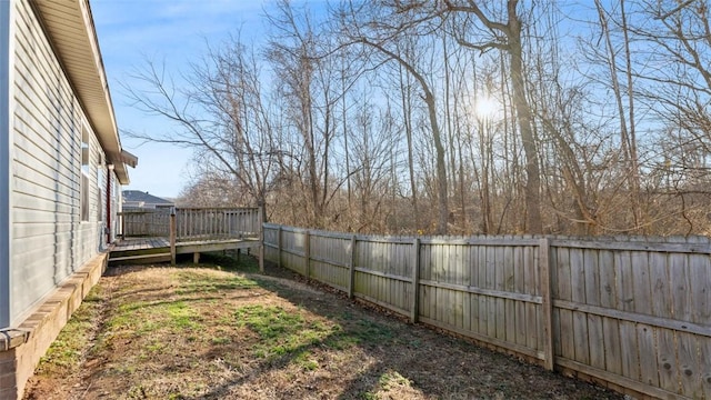 view of yard with a fenced backyard and a wooden deck