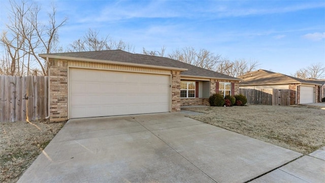 ranch-style home featuring driveway, brick siding, an attached garage, and fence