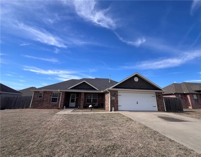 ranch-style house featuring a garage, brick siding, concrete driveway, and fence