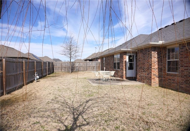 view of yard featuring a patio area and a fenced backyard