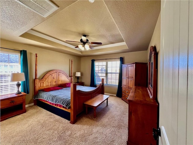 bedroom featuring visible vents, a raised ceiling, and carpet flooring