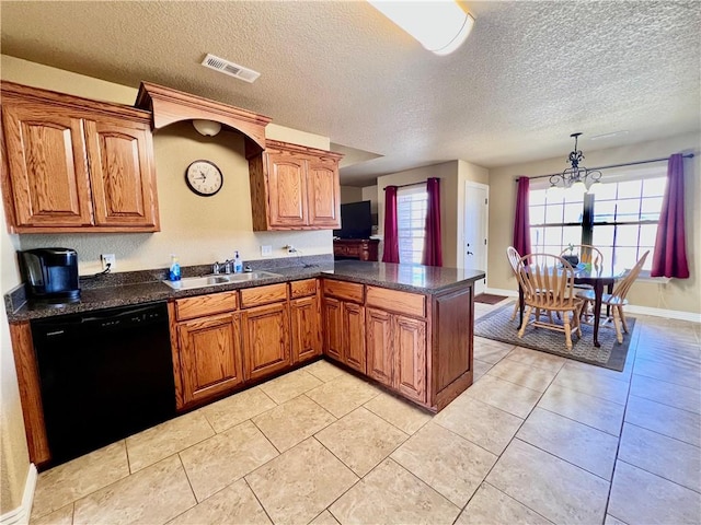 kitchen featuring visible vents, black dishwasher, and brown cabinetry