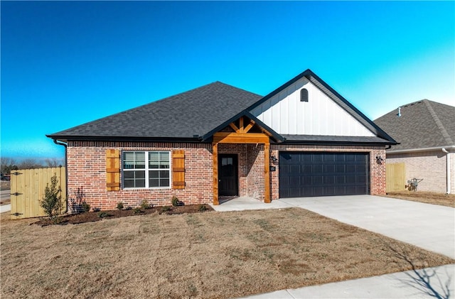 view of front of home with a garage, a front yard, and brick siding