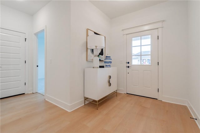 entryway with light wood-style floors and baseboards