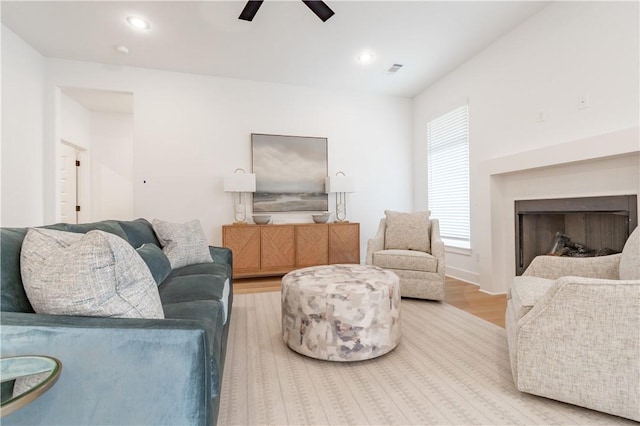 living area featuring a fireplace, recessed lighting, visible vents, a ceiling fan, and wood finished floors