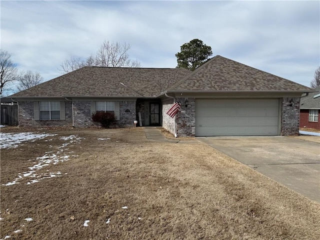 ranch-style home featuring a shingled roof, concrete driveway, brick siding, and a garage