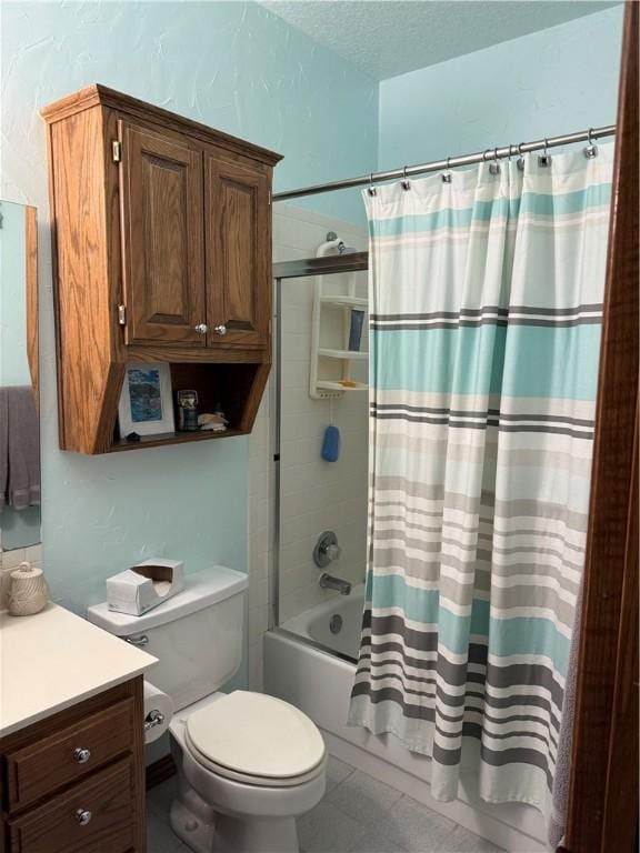 bathroom featuring shower / bath combination with curtain, toilet, vanity, and a textured ceiling