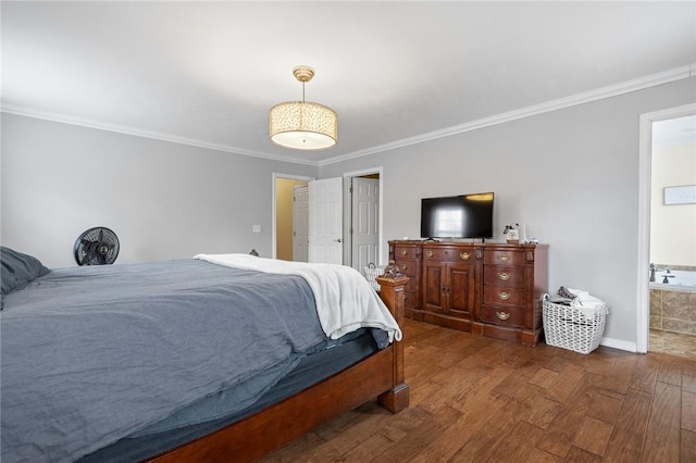 bedroom featuring ensuite bath, crown molding, and dark wood-type flooring