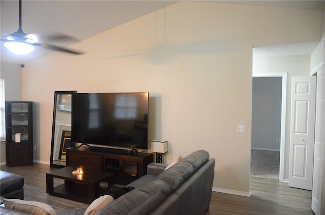 living area featuring dark wood-style floors, ceiling fan, and baseboards