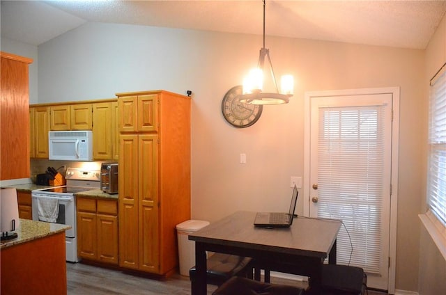 kitchen with dark wood finished floors, hanging light fixtures, an inviting chandelier, vaulted ceiling, and white appliances