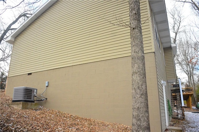 view of side of home with stairway and central air condition unit