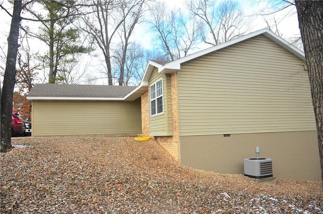 view of property exterior with central air condition unit and crawl space