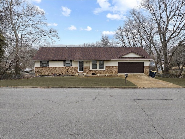 ranch-style home featuring a garage, brick siding, concrete driveway, and a front yard