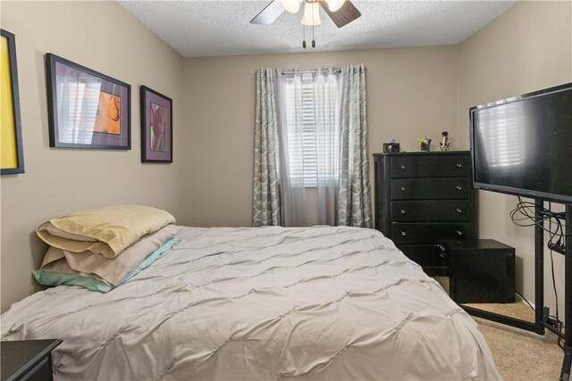 bedroom featuring carpet floors, a textured ceiling, and ceiling fan