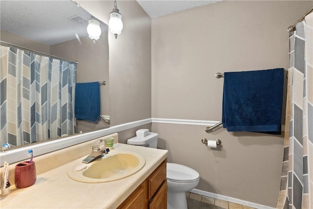 bathroom with visible vents, toilet, a textured ceiling, baseboards, and vanity