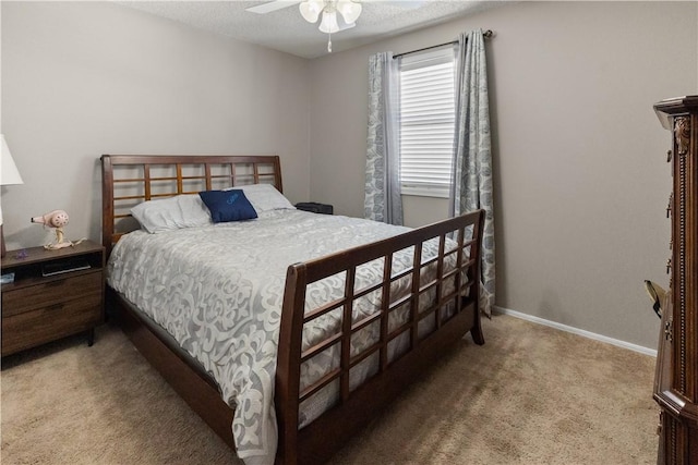 carpeted bedroom featuring baseboards, a ceiling fan, and a textured ceiling