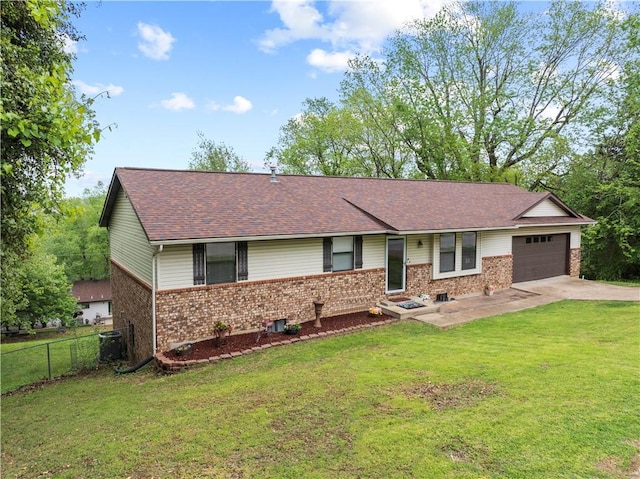 ranch-style house featuring a garage, a front lawn, fence, brick siding, and concrete driveway