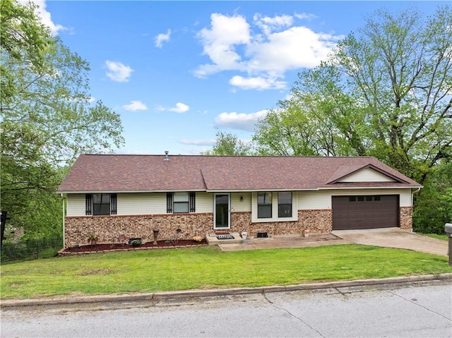 single story home featuring brick siding, an attached garage, driveway, and a front yard