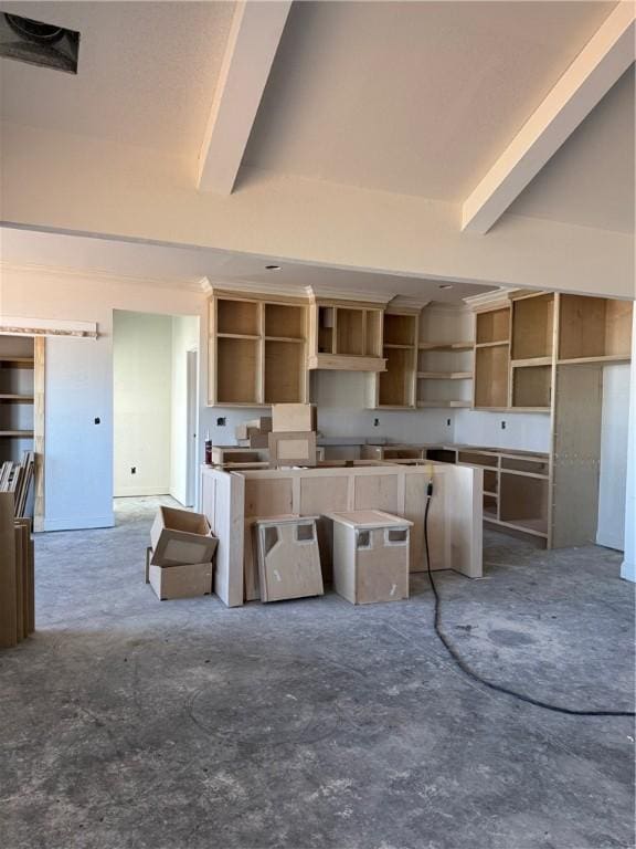 kitchen featuring open shelves, unfinished concrete flooring, and beam ceiling