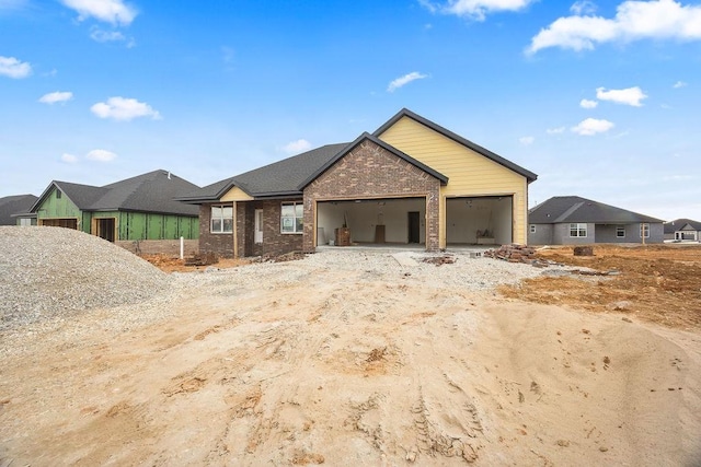 view of front of home featuring brick siding and an attached garage