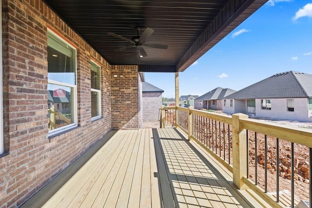 deck featuring a ceiling fan and a residential view