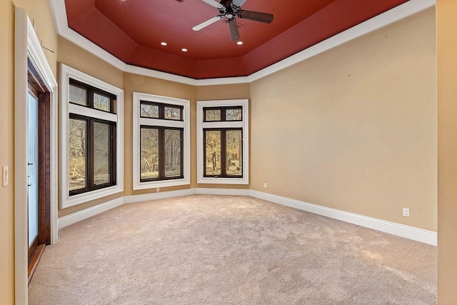 spare room featuring plenty of natural light, baseboards, and light colored carpet