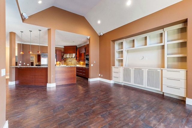 unfurnished living room featuring lofted ceiling, baseboards, dark wood-style flooring, and recessed lighting