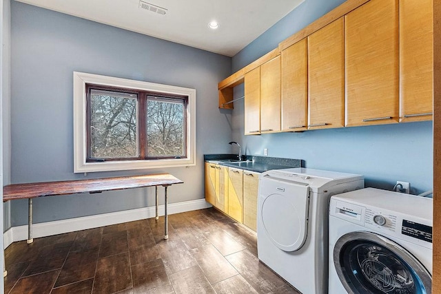 clothes washing area with cabinet space, baseboards, visible vents, dark wood-style flooring, and washing machine and clothes dryer