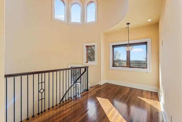 empty room featuring dark wood-style flooring and baseboards