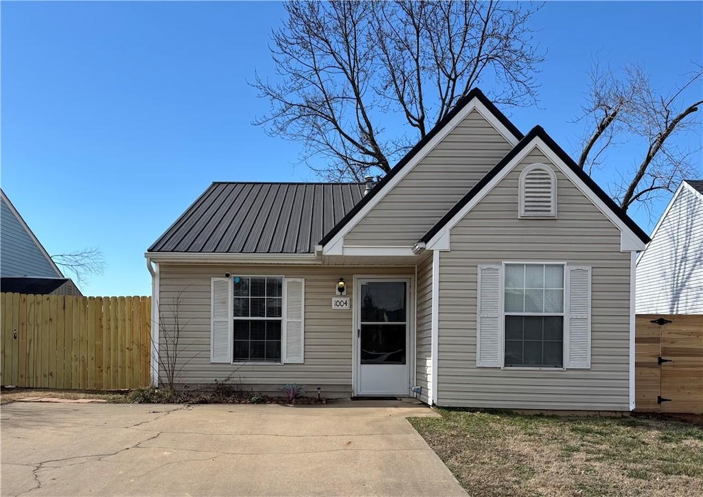 1004 S 24th Pl, Rogers, AR 72758 - view of front of home with fence, metal roof, and a patio