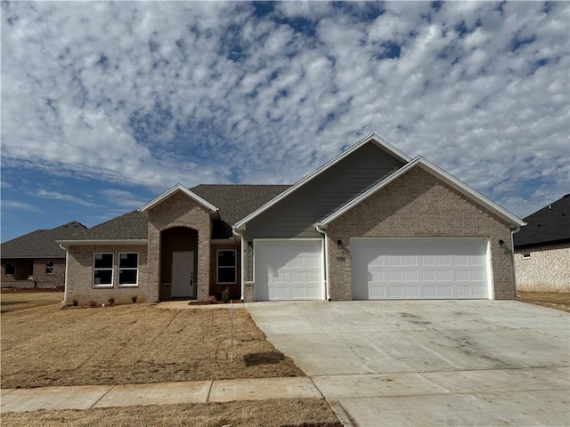 ranch-style house featuring concrete driveway, brick siding, and an attached garage