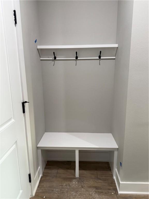 mudroom with dark wood-style floors