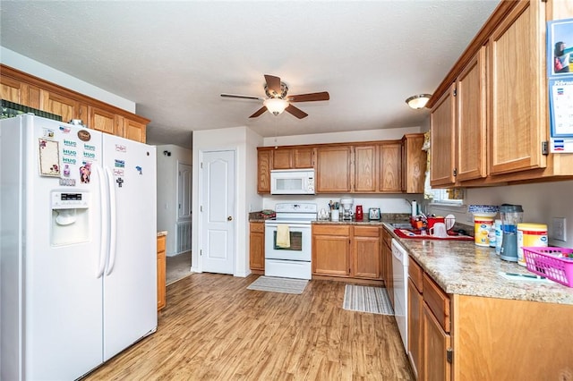 410 Paradise Heights Dr, Berryville, AR 72616 - kitchen featuring white appliances, brown cabinetry, light wood-style flooring, ceiling fan, and light countertops