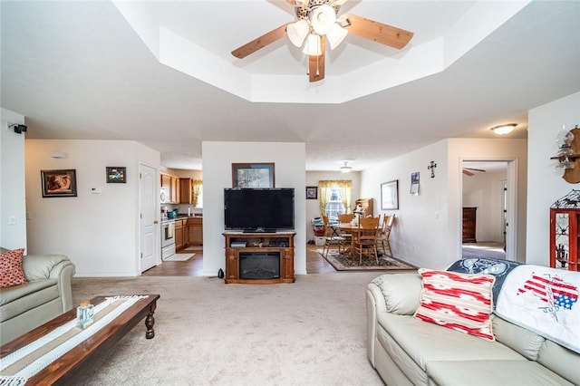 410 Paradise Heights Dr, Berryville, AR 72616 - living area with a raised ceiling, light colored carpet, and ceiling fan