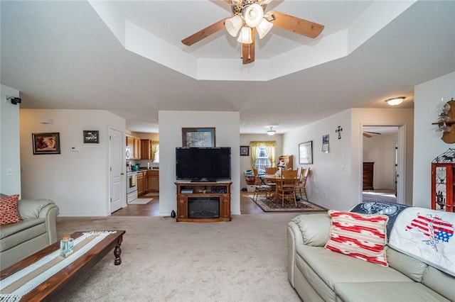 410 Paradise Heights Dr, Berryville, AR 72616 - living room featuring a raised ceiling, light carpet, and ceiling fan