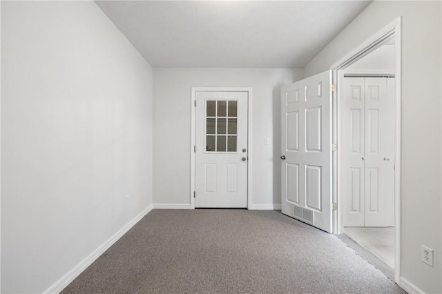 carpeted empty room featuring visible vents and baseboards