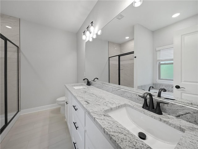 full bathroom with toilet, a shower stall, baseboards, and a sink