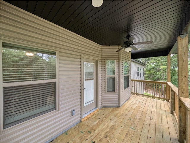 wooden deck featuring a ceiling fan