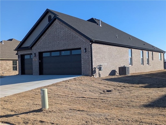 view of property exterior with concrete driveway, brick siding, an attached garage, and central air condition unit