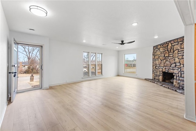 916 S 25th Pl, Rogers, AR 72758 - unfurnished living room featuring ceiling fan, light wood finished floors, a stone fireplace, and recessed lighting