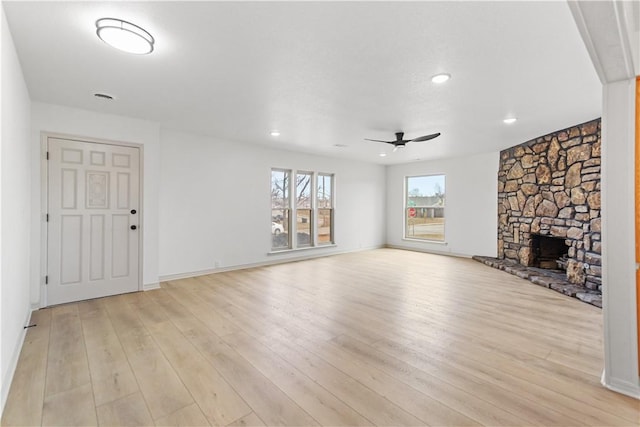 916 S 25th Pl, Rogers, AR 72758 - unfurnished living room with ceiling fan, light wood-style flooring, a stone fireplace, and recessed lighting