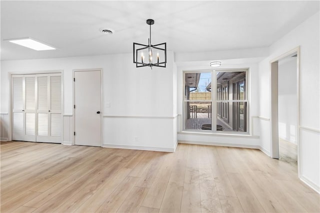 916 S 25th Pl, Rogers, AR 72758 - unfurnished dining area featuring wood finished floors and a chandelier