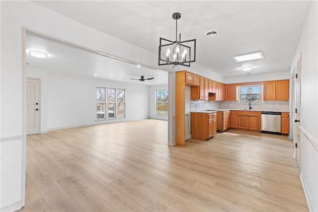 916 S 25th Pl, Rogers, AR 72758 - kitchen featuring stainless steel dishwasher, a chandelier, light wood-type flooring, and decorative backsplash