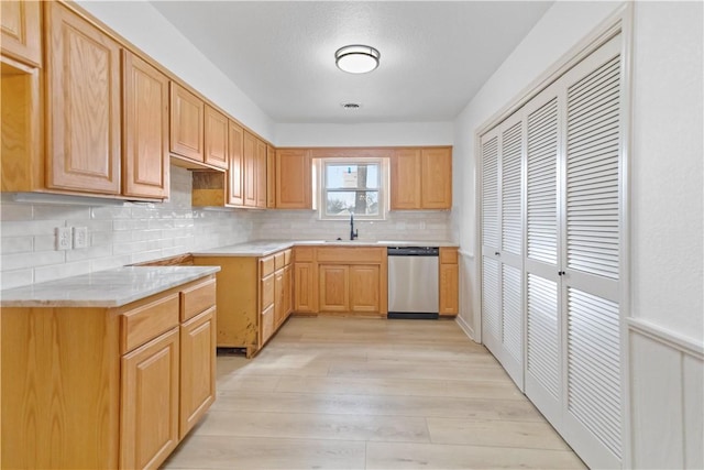 916 S 25th Pl, Rogers, AR 72758 - kitchen featuring stainless steel dishwasher, light wood-style flooring, tasteful backsplash, and light stone counters