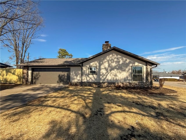 916 S 25th Pl, Rogers, AR 72758 - view of home's exterior featuring a chimney, a garage, and concrete driveway