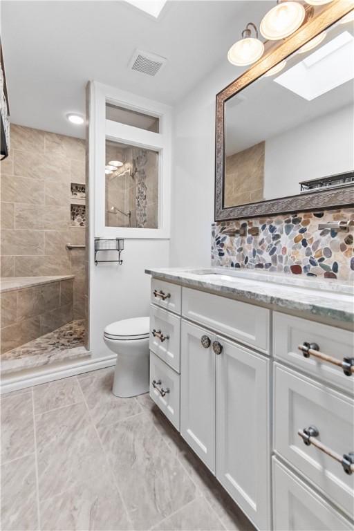 916 S 25th Pl, Rogers, AR 72758 - bathroom featuring vanity, walk in shower, and a skylight