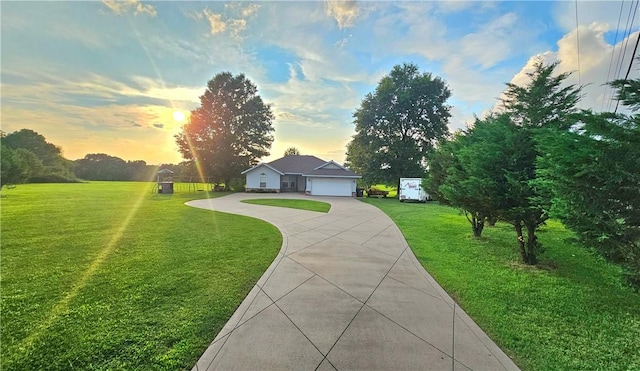 ranch-style house featuring concrete driveway, a yard, and an attached garage