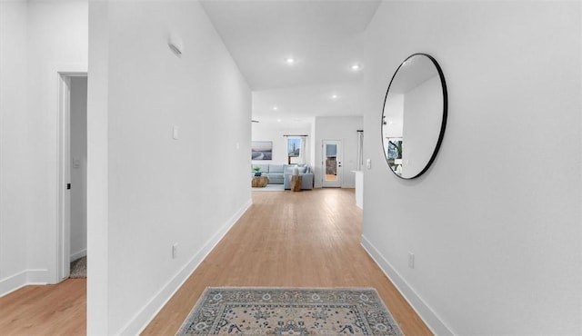 corridor featuring recessed lighting, baseboards, and wood finished floors