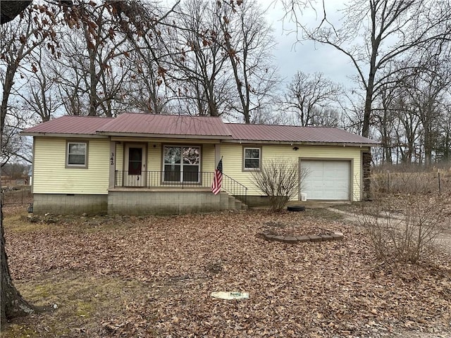 ranch-style home featuring a porch, crawl space, metal roof, and an attached garage