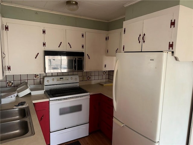 kitchen with light countertops, white appliances, decorative backsplash, and white cabinets